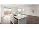 Bright kitchen featuring a large island with sink and stainless steel dishwasher at 10328 Apefly St, Las Vegas, NV 89141