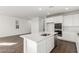 Spacious kitchen features stainless appliances, white cabinets and large island for entertaining at 10328 Apefly St, Las Vegas, NV 89141