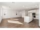 Modern kitchen with stainless steel appliances, white cabinets and large island overlooking living area at 10328 Apefly St, Las Vegas, NV 89141
