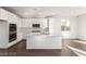 Modern kitchen with stainless steel appliances, white cabinets, and large island at 10328 Apefly St, Las Vegas, NV 89141