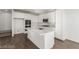 Contemporary kitchen with stainless steel appliances, white cabinets and an expansive island at 10328 Apefly St, Las Vegas, NV 89141