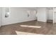 Open-concept living room featuring wood-look tile flooring and ample natural light at 10328 Apefly St, Las Vegas, NV 89141