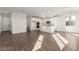 Open-concept living space with a modern kitchen, dining area, and sleek flooring at 10328 Apefly St, Las Vegas, NV 89141