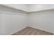Empty walk-in closet featuring neutral carpet and wood trim closet rods at 10328 Apefly St, Las Vegas, NV 89141