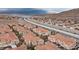 An aerial view shows this residential area nestled near highways and stunning mountain landscapes at 10550 W Alexander Rd # 2082, Las Vegas, NV 89129