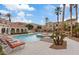 Resort-style pool area with sun loungers, palm trees, and a relaxing spa at 10550 W Alexander Rd # 2082, Las Vegas, NV 89129
