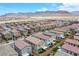 Aerial view of similar model homes showcases desert landscape and mountain views at 10590 Dryades Ave, Las Vegas, NV 89166