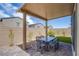 Relax on this covered patio with a brick floor and enjoy the beautiful landscaping and blue skies at 10590 Dryades Ave, Las Vegas, NV 89166
