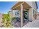 Charming covered back patio with brick flooring and cozy outdoor seating area for relaxing and entertaining at 10590 Dryades Ave, Las Vegas, NV 89166
