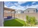 Well manicured backyard features a brick patio and artificial turf for easy maintenance at 10590 Dryades Ave, Las Vegas, NV 89166