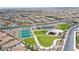 Aerial view showcases the community park with playground, tennis courts, grassy areas, and pathways at 10590 Dryades Ave, Las Vegas, NV 89166