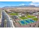 Aerial view of the community park with walking trails, playground, tennis courts, and parking at 10590 Dryades Ave, Las Vegas, NV 89166