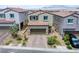 Stunning aerial view of a two-story home with desert landscaping, a tile roof and a two-car garage at 10590 Dryades Ave, Las Vegas, NV 89166