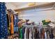 Spacious walk-in closet featuring rods and shelving, offering ample storage for an organized wardrobe at 10590 Dryades Ave, Las Vegas, NV 89166