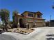 Inviting two-story home featuring a tile roof, stone accents, and manicured desert landscaping at 10601 Turquoise Valley Dr, Las Vegas, NV 89144
