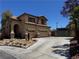 Beautiful two-story home with a tile roof, desert landscaping, and a spacious driveway at 10601 Turquoise Valley Dr, Las Vegas, NV 89144