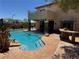 Sparkling backyard pool with rock waterfall and stone patio, perfect for outdoor entertaining at 10601 Turquoise Valley Dr, Las Vegas, NV 89144