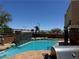 Backyard pool with rock features, providing a tranquil and private outdoor oasis at 10601 Turquoise Valley Dr, Las Vegas, NV 89144