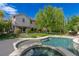Inviting backyard with a sparkling pool, lush greenery, and meticulously landscaped yard, creating a private oasis at 10761 Capesthorne Way, Las Vegas, NV 89135