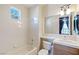 Cozy bathroom with a tub, shower, and a well-lit mirror above the sink at 10761 Capesthorne Way, Las Vegas, NV 89135