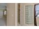 Bathroom with tiled shower and a glass block window at 10761 Capesthorne Way, Las Vegas, NV 89135