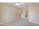 Spacious bedroom with neutral carpeting and ceiling fan at 10761 Capesthorne Way, Las Vegas, NV 89135