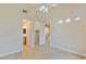 Bright bedroom with a walk-in closet and bathroom entrance, complemented by tiled floors and a ceiling fan at 10761 Capesthorne Way, Las Vegas, NV 89135