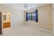 Inviting bedroom with carpet, natural light, and an ensuite bathroom at 10761 Capesthorne Way, Las Vegas, NV 89135