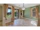 Well-lit dining area with large windows offering lovely views of the backyard's greenery at 10761 Capesthorne Way, Las Vegas, NV 89135