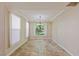 Well-lit dining room featuring neutral colors, travertine floors and a view of the backyard at 10761 Capesthorne Way, Las Vegas, NV 89135