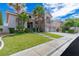 Two-story home with a three-car garage, stone accents, balcony, and green lawn at 10761 Capesthorne Way, Las Vegas, NV 89135