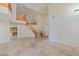 Open foyer with travertine floors, curved staircase and high ceilings at 10761 Capesthorne Way, Las Vegas, NV 89135