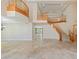 Spacious foyer with travertine floors, grand staircase and elegant chandelier at 10761 Capesthorne Way, Las Vegas, NV 89135