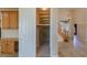 Open floor plan with a hidden staircase entrance and travertine flooring at 10761 Capesthorne Way, Las Vegas, NV 89135