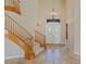 Foyer with stone flooring, a staircase, and a decorative chandelier at 10761 Capesthorne Way, Las Vegas, NV 89135