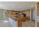 Spacious kitchen with wood cabinets, travertine floors, and modern appliances at 10761 Capesthorne Way, Las Vegas, NV 89135
