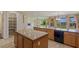 Open kitchen boasts an island, granite counters, and views of a beautifully landscaped backyard at 10761 Capesthorne Way, Las Vegas, NV 89135