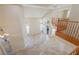 Bright living room with tile flooring, high ceilings, and wood banister at 10761 Capesthorne Way, Las Vegas, NV 89135