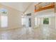 Open living room with stone flooring, high ceilings, and natural light at 10761 Capesthorne Way, Las Vegas, NV 89135