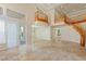 Open living room with stone flooring, staircase, and natural light at 10761 Capesthorne Way, Las Vegas, NV 89135
