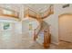 Open living room with stone flooring, staircase, and natural light at 10761 Capesthorne Way, Las Vegas, NV 89135