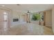 Cozy living room with travertine floors, fireplace and lots of natural light at 10761 Capesthorne Way, Las Vegas, NV 89135