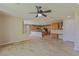 Open living space with travertine flooring and a kitchen area with wood cabinets at 10761 Capesthorne Way, Las Vegas, NV 89135