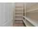 Walk-in pantry with ample shelving for organized storage and easy access to kitchen essentials at 10761 Capesthorne Way, Las Vegas, NV 89135