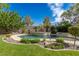 Custom pool and spa featuring rock accents and well-manicured landscaping for ultimate relaxation at 10761 Capesthorne Way, Las Vegas, NV 89135