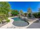 Gorgeous pool and spa combination in a serene backyard setting with lush landscaping and a rock border at 10761 Capesthorne Way, Las Vegas, NV 89135