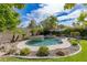 Tranquil backyard oasis with a custom pool and lush tropical landscaping at 10761 Capesthorne Way, Las Vegas, NV 89135