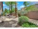 Lush backyard featuring desert landscaping, a seating area, and a charming brick perimeter wall for privacy at 11244 Gammila Dr, Las Vegas, NV 89141