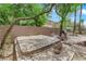 Backyard with a hot tub, a grill, a seating area and perimeter block wall, set amongst mature trees at 11244 Gammila Dr, Las Vegas, NV 89141