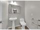 Bathroom featuring pedestal sink, modern fixtures, and a tiled floor, offering a clean design at 11244 Gammila Dr, Las Vegas, NV 89141